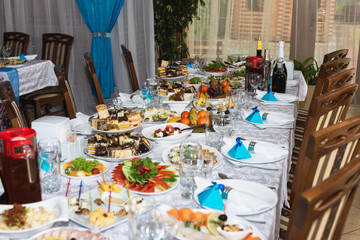 Served wedding table with snacks for different flavors