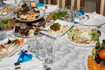 Served wedding table with snacks for different flavors