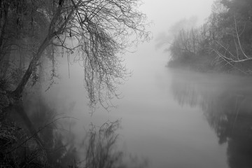 Romantic foggy river at dawn