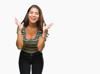 Obraz premium Young beautiful arab woman over isolated background celebrating crazy and amazed for success with arms raised and open eyes screaming excited. Winner concept