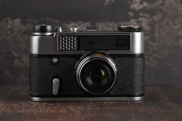 The old rangefinder camera on a brown cement background.