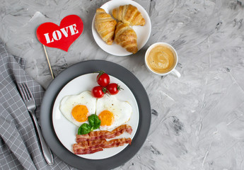 Tasty Fried Egg in the Shape of a Heart Served on a White Plate with Bacon Tomato Basil Pepper Gray Background Valentine Day Breakfast