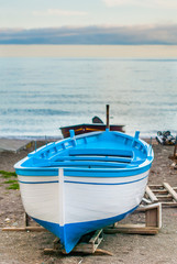 Naklejka premium Portrait of a blue and white fishing boat, waiting to cross the sea