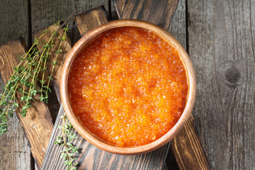 Red caviar in a wooden bowl. Rustic style. Top view