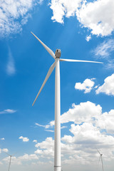 The wind generator is in bright cloudy sky. Eco energy concept.