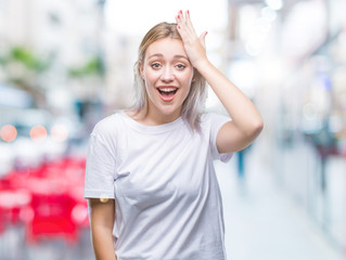 Young blonde woman over isolated background surprised with hand on head for mistake, remember error. Forgot, bad memory concept.