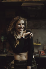 Naklejka na ściany i meble beautiful girl with long hair in the garage repairing a motorcycle