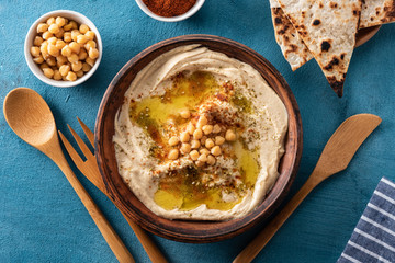Classic Hummus with chickpeas, paprika, olive oil and oriental spices. Mediterranean popular snack of chickpeas and tahini pasta.