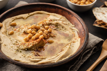 Classic Hummus with chickpeas, paprika, olive oil and oriental spices. Mediterranean popular snack of chickpeas and tahini pasta.