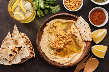 Classic Hummus with chickpeas, paprika, olive oil and oriental spices. Mediterranean popular snack of chickpeas and tahini pasta. - obrazy, fototapety, plakaty