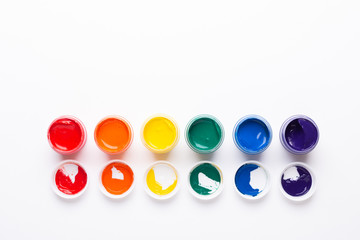 Multicolored gouache on a white background Isolated Paints in containers Top view Copy space
