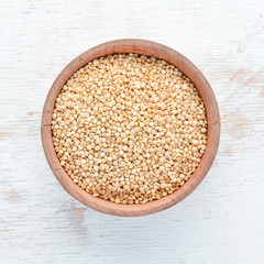 White quinoa On a white wooden background. Top view. Free copy space.