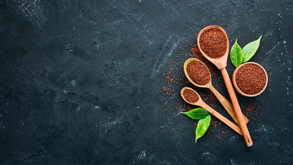 Fototapeta na wymiar Superfood Red quinoa. On a black background. Top view. Free copy space.