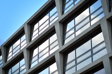 Abstract fragment of modern architecture, walls made of glass and concrete.