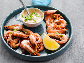 Shrimp glazed in soy sauce with green onion and lemon.