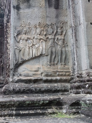 Group of graceful apsara dancers on a wall in Angkor, Cambodia.
