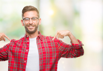 Young handsome man over isolated background looking confident with smile on face, pointing oneself with fingers proud and happy.