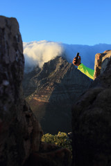 Fototapeta na wymiar view of Table Mountain with clouds and hand taking selfie