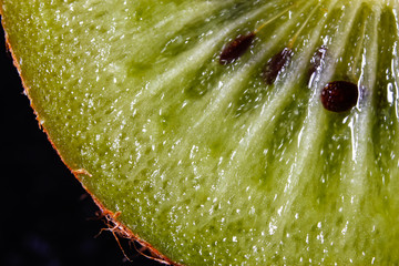 Slice of fresh kiwi fruit, macro background