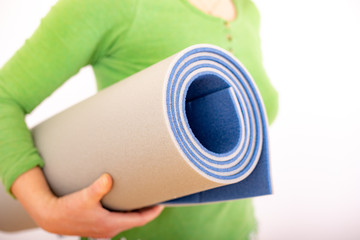 Woman with gymnastics mat