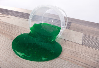 Green slime flowing out of a plastic bucket
