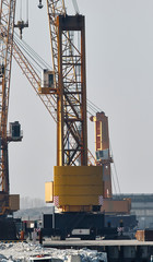 Fototapeta na wymiar Two large crane in commercial harbor​ for​ lifting the​ he