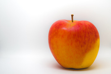 A close-up of a natural looking apple isolated on white background