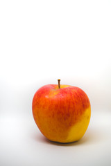 A close-up of a natural looking apple isolated on white background