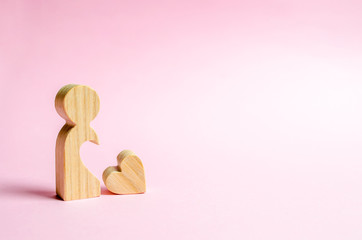 A lonely figure of a man or a woman with a heart that has dropped out of her body. Love search concept. Dating on Valentine's Day. The desire to find a relationship and love partner. Loneliness