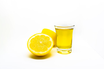 A Mexican tequila shot with lemon on a white isolated background