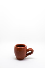 Two tiny iconic brown hot chocolate mugs isolated on a white background
