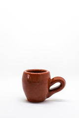 Two tiny iconic brown hot chocolate mugs isolated on a white background