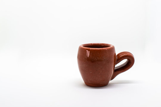 Two tiny iconic brown hot chocolate mugs isolated on a white background