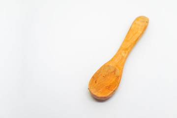 Small light wooden spoon on a white isolated background with blank space for text