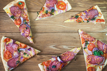 Sliced pizza on wooden surface. Top view 
