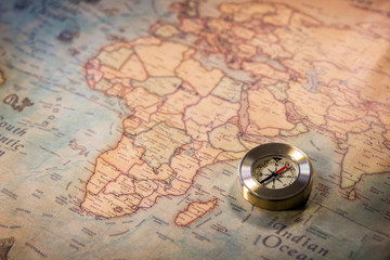 Travel concept background, vintage compas and old earth map © daliu
