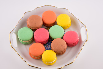Multi-coloured macarons on a porcelain plate
