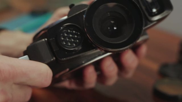 Holding 8mm Movie Camera.