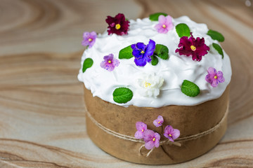 Fototapeta na wymiar Sweet, traditional Easter bread, decorated with icing and flowers. Kulich traditional