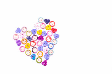 Heart shape created from colorful heart shaped and round buttons