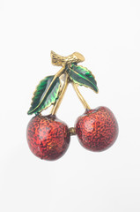 golden enamelled brooch sweet cherry isolated on white