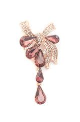 golden brooch bow with diamonds and rubies and drops isolated on white