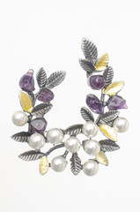 silver brooch twig with pearls and natural stones isolated on white