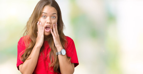 Young beautiful brunette woman wearing red t-shirt over isolated background afraid and shocked with surprise expression, fear and excited face.