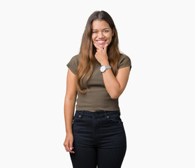 Young beautiful brunette woman over isolated background looking confident at the camera with smile with crossed arms and hand raised on chin. Thinking positive.