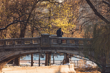 Happy young couple lovers dating on the bridge in the park
