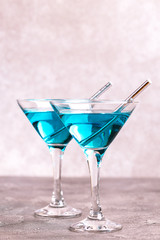 Two glasses of trendy blue wine with paper straws