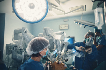 Minimal invasive robot surgical system in hospital. Robotic technology equipment, machine arm...