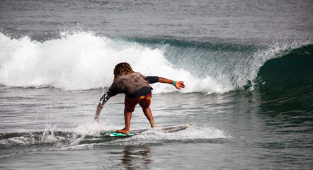 Surfing. A young man slides on a Board on the waves of the ocean. Cape Verde