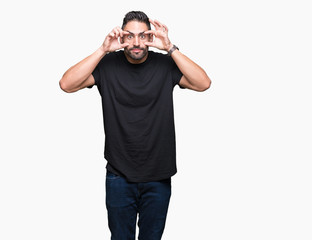 Fototapeta premium Young handsome man over isolated background Trying to open eyes with fingers, sleepy and tired for morning fatigue